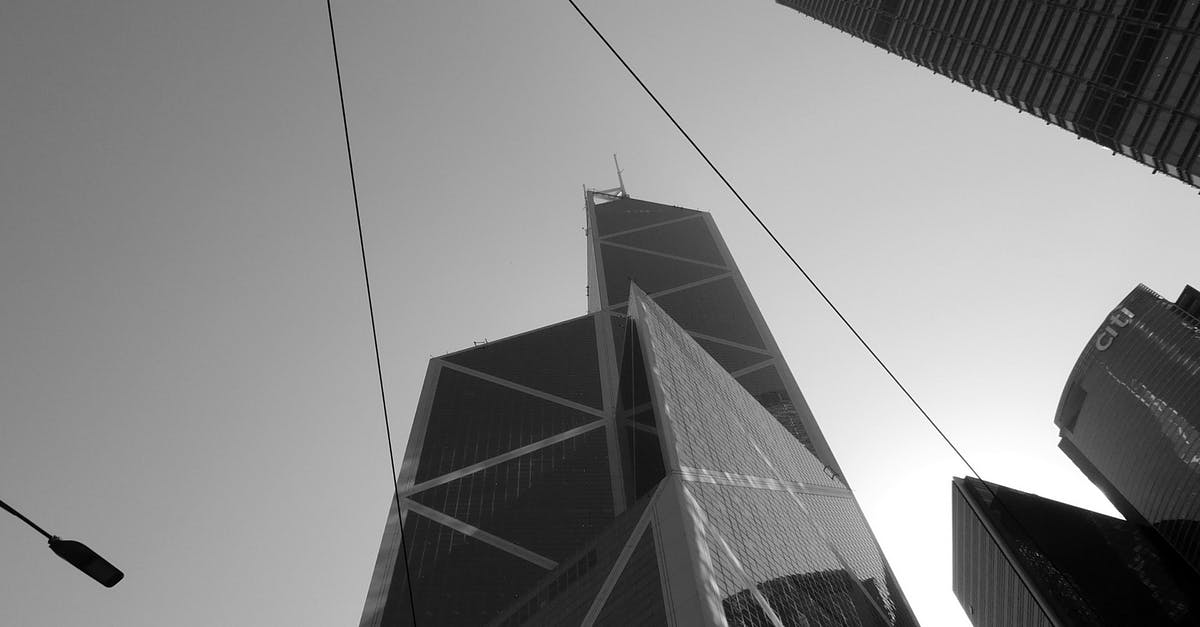 From Shenzhen to Hong Kong as a Western traveller? - Futuristic skyscrapers with glass facades under cloudless sky