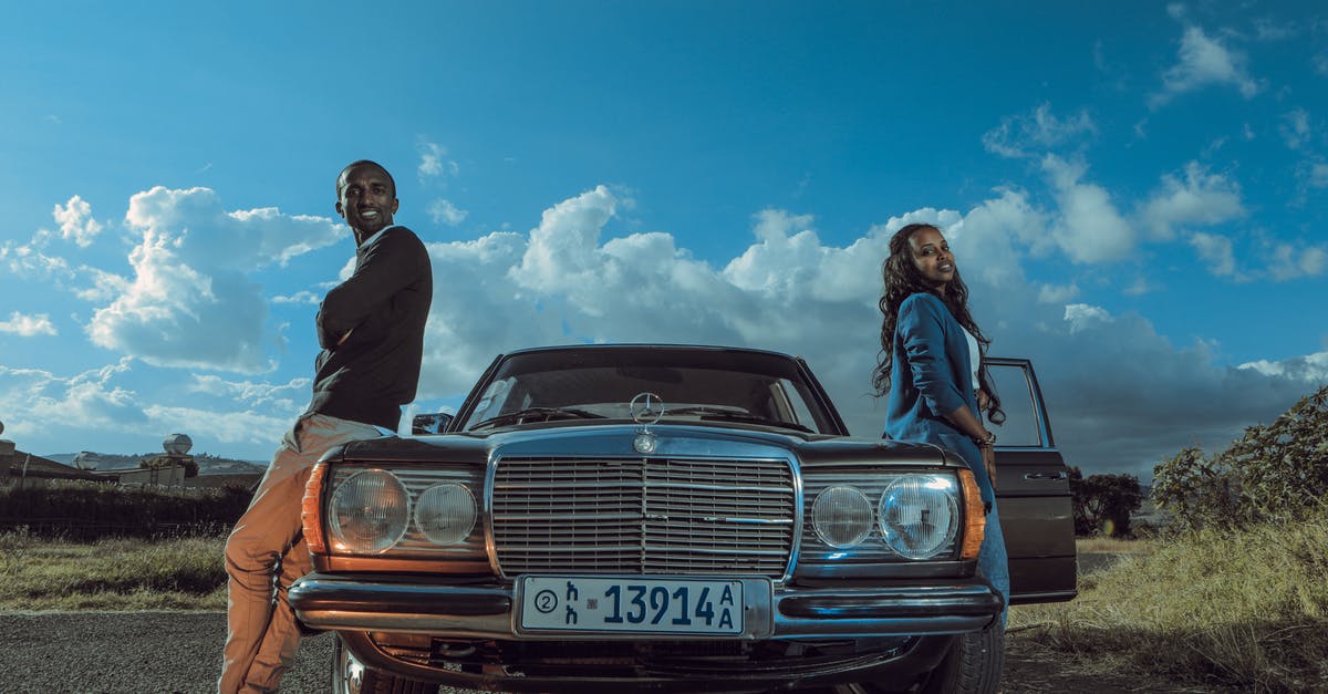 Full listing of rental car category - Stylish black couple standing near retro car in countryside