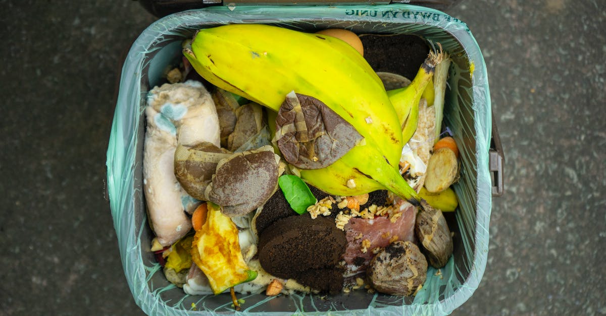 Garbage bin on Khao San Road, Bangkok - Banana Fruit and Meat in Blue Plastic Container