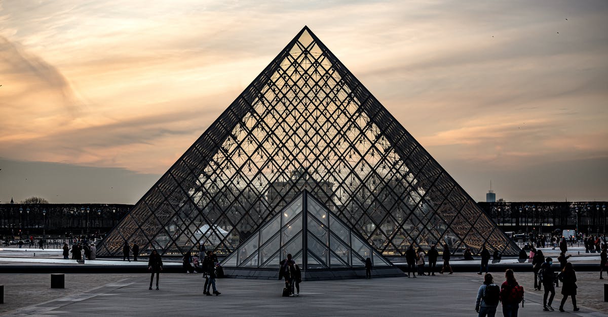 Gazole vs diesel in France - People Walking Near Pyramid Glass Building