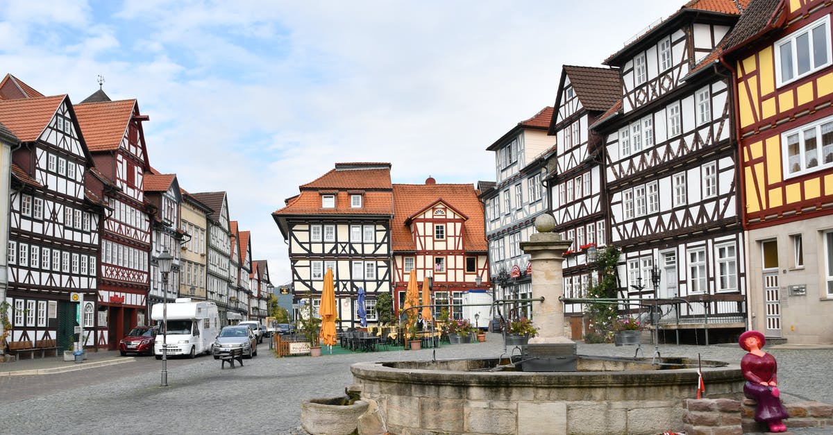 Germany inter state traveling - White and Brown Concrete Building Near Body of Water