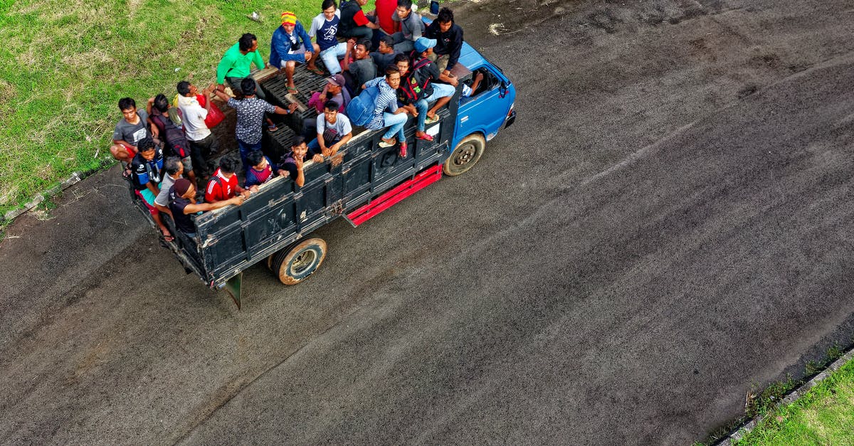 Get an international driving license in Indonesia - Aerial Photo of People Riding in Truck