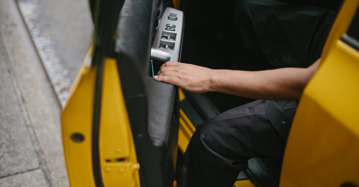 Get different Uber driver - Unrecognizable man getting out of yellow car