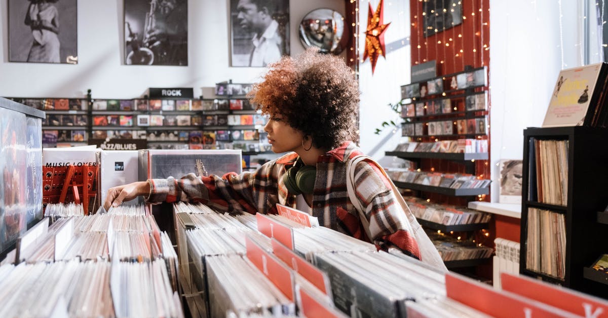 Getting a Schengen visa while interning in Canada - Woman in Red and White Plaid Shirt Standing in Front of Books