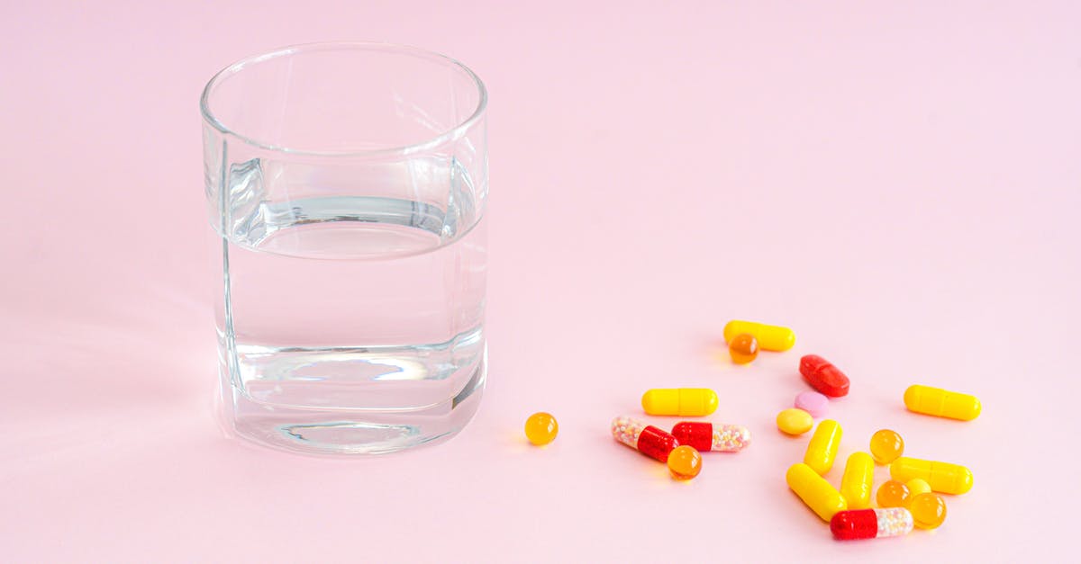 Getting antiseptic and antibiotic in Japan - Clear Drinking Glass With Yellow and Pink Tablets