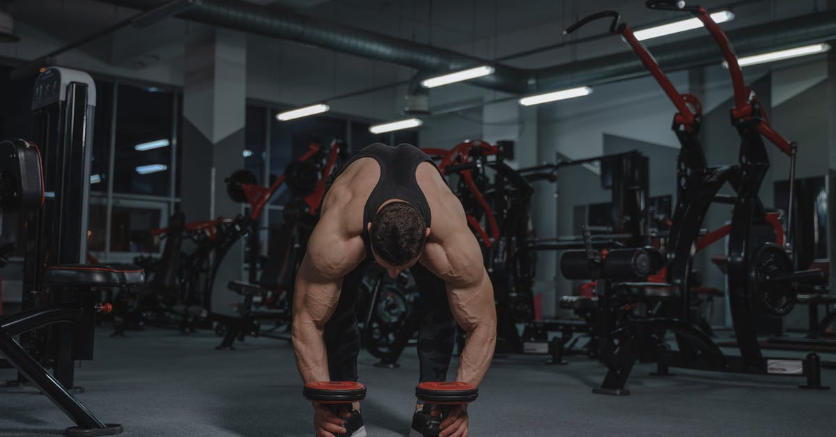 Getting around the UK by Train - Man Getting the Dumbbells on the Floor 