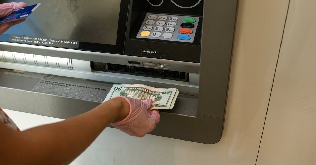 Getting cash from ATM at MEX airport - Person Deposits Money on an ATM