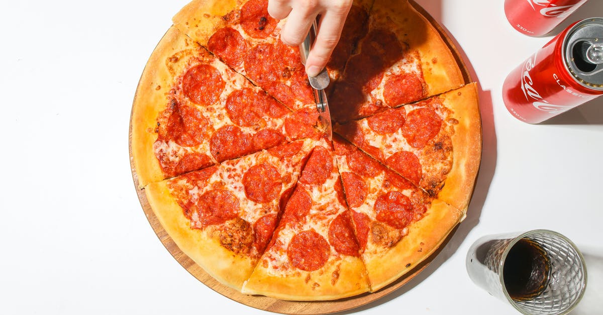 Getting Dutch Schengen visa from the Italian embassy - Person Slicing A Pizza With A Pizza Cutter