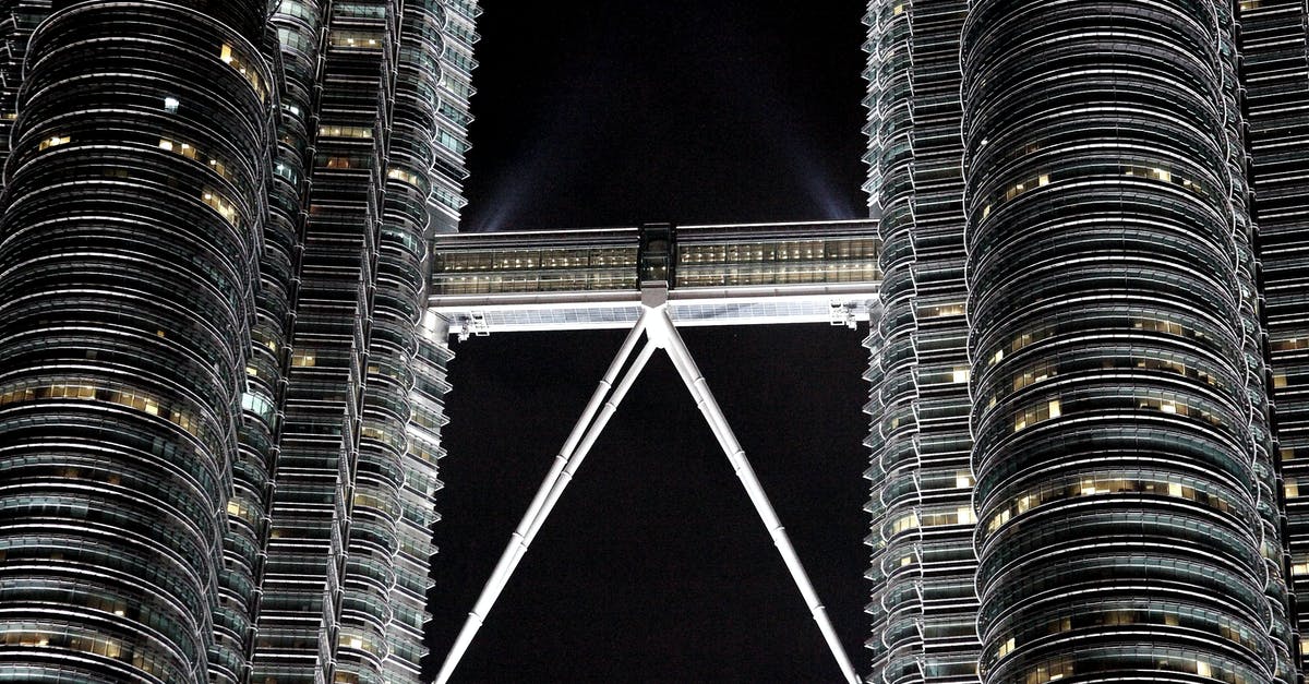 Getting from Bangladesh to Malaysia with current restrictions - Twin high rise towers at night