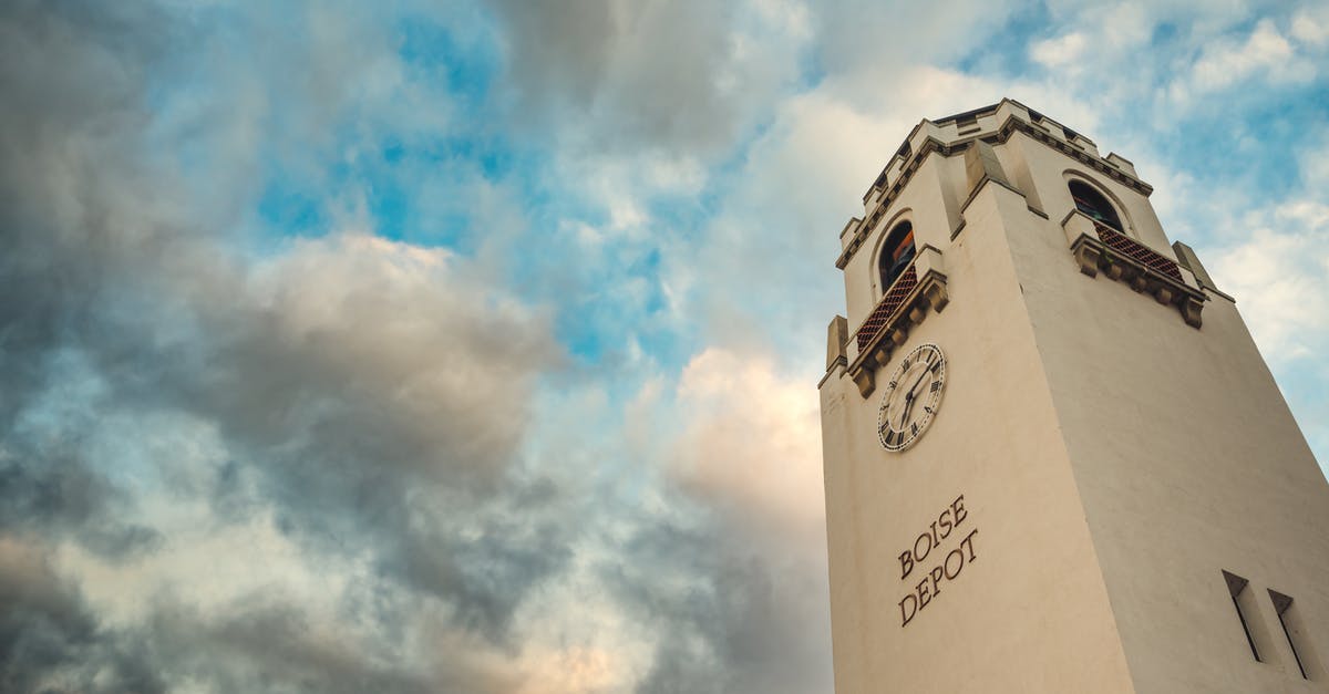 Getting from Halifax, Canada to the US by bus/train? - From below of aged tower with arched windows and clock of Boise Depot train station against picturesque cloudy sky