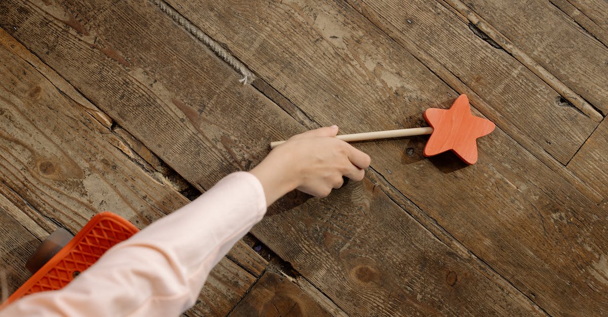 Getting from the Frankfurt-Hahn airport to Saarbrücken (Germany) - A Hand Picking the Wooden Wand on the Floor