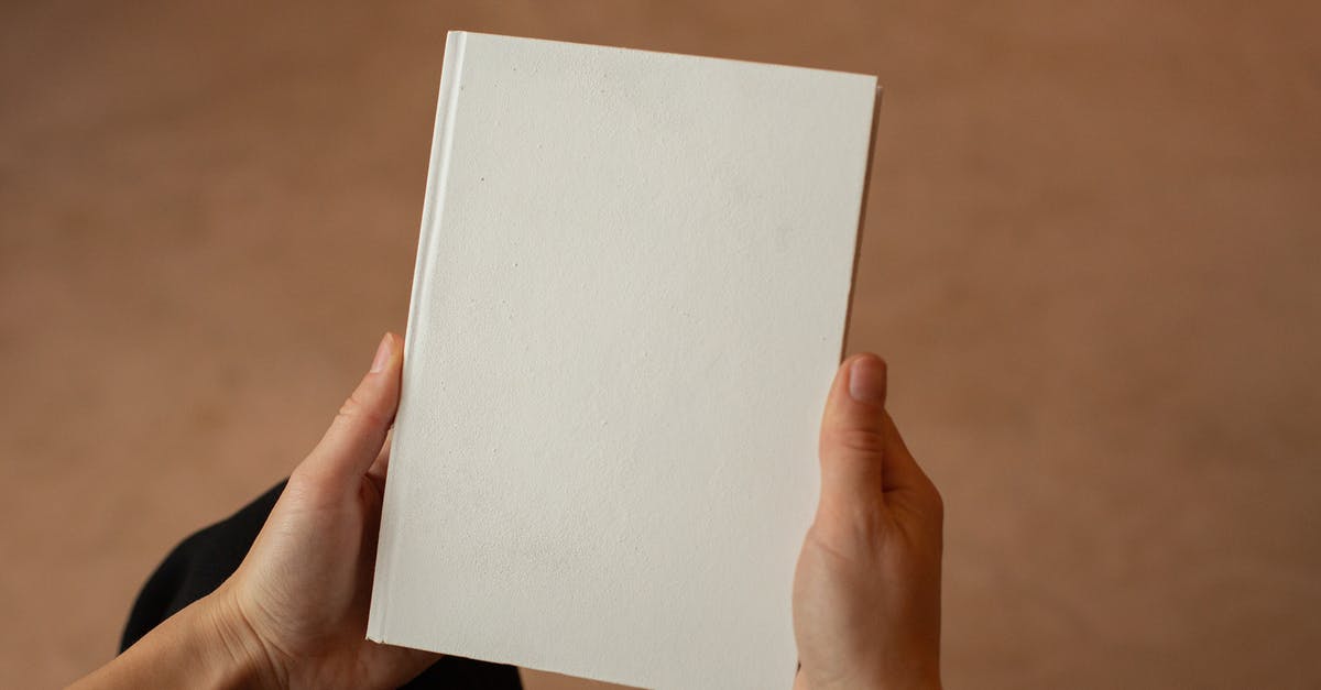 Getting from Toronto to New York - Person holding hardcover book with blank cover