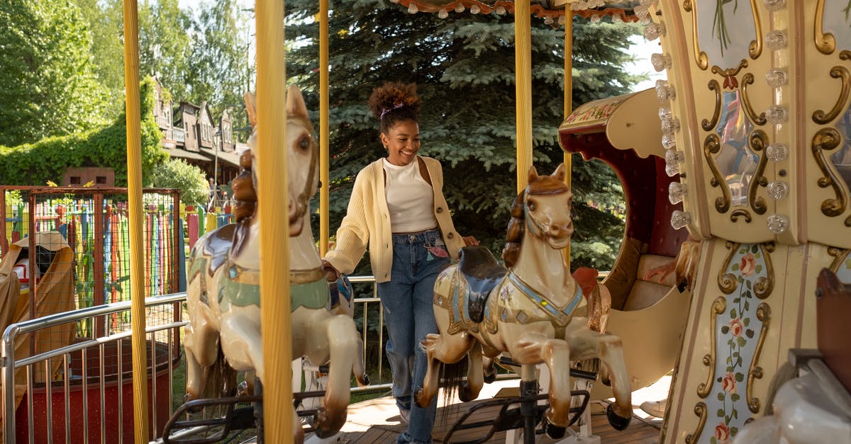 Getting to Laulupidu – Estonia - Cheerful teenage girl getting on carousel