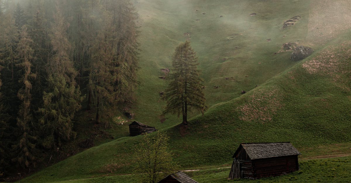 Getting to Shatili village from Tbilisi? - Old wooden barns on green hill