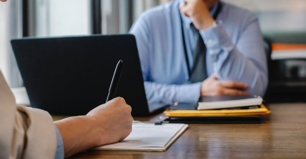 Getting US visa for a job meeting - Crop anonymous female filling questionnaire when applying for job sitting in employer office