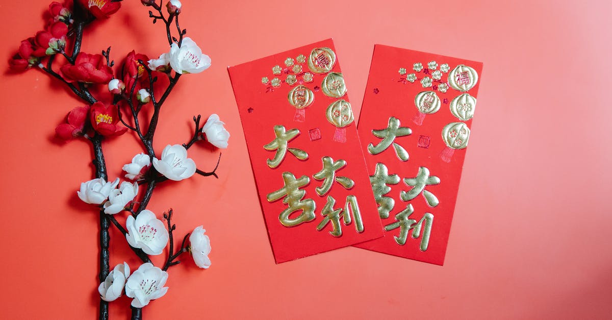 Gifts for Chinese hosts? - Oriental envelopes against decorative blooming Prunus on red background