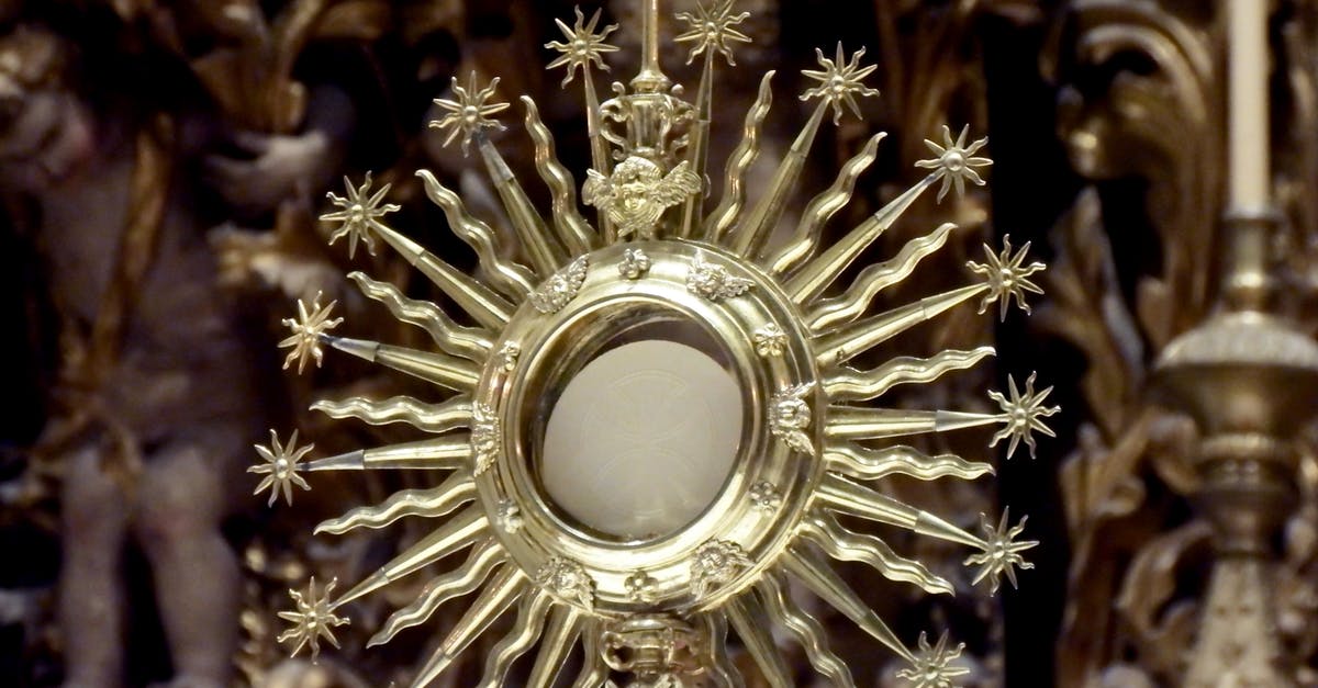 Giving details to Airbnb host - Golden monstrance against blurred church interior