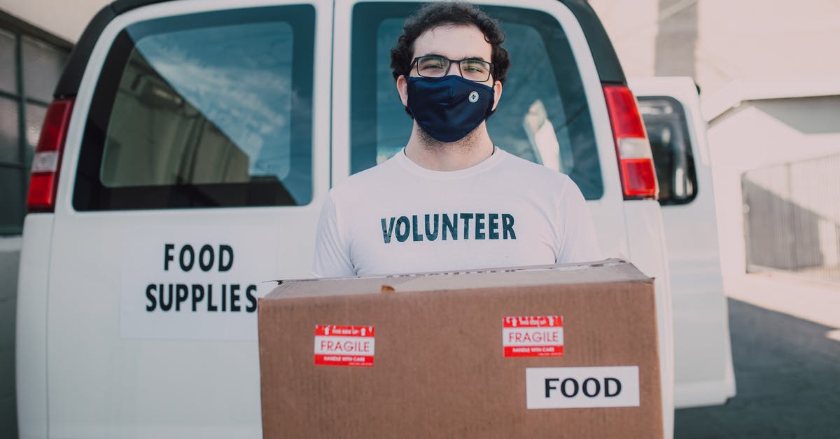 Giving First Aid in the USA - A Man Carrying a Box with Food Label