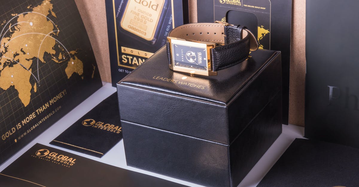 Global Entry vs Nexus Card [duplicate] - Rectangular Gold-colored Watch With Black Strap on Black Box