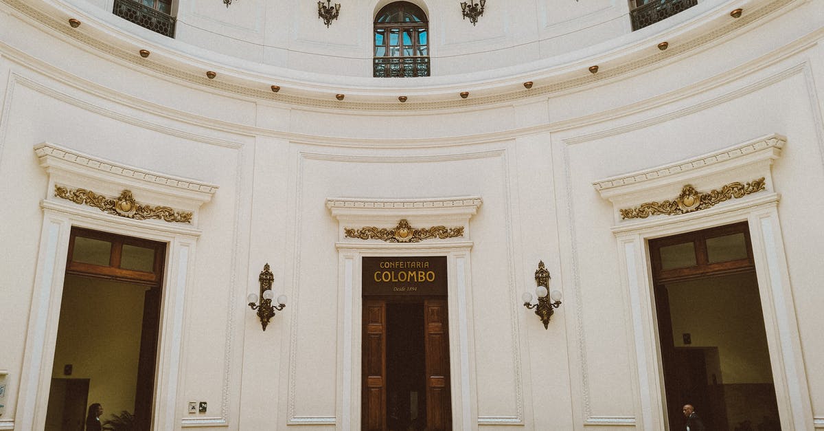 Going to Argentina from Brazil without a Brazilian entry stamp - Low angle fragment of interior of historical building with white stone walls and arched windows in colonial style in Rio de Janeiro in Brazil