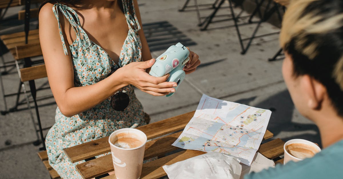 Going to Bulgaria with Turkish tourist visa. Is this possible? - Crop ethnic couple with photo camera and takeaway coffee