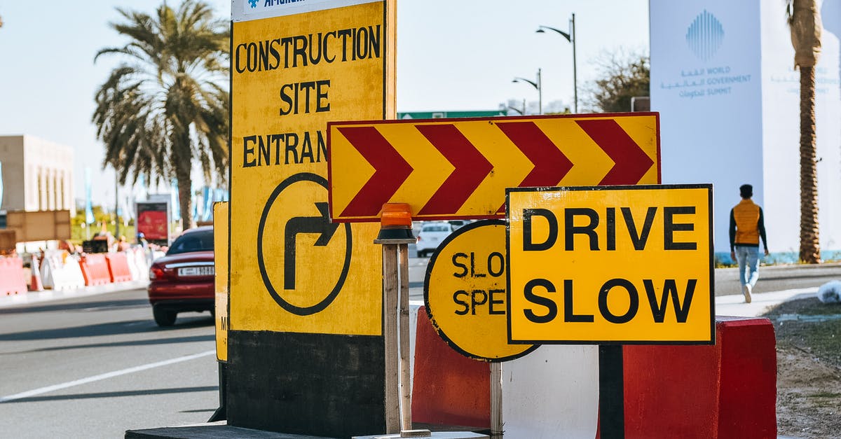 Going to St. Petersburg not finding my usual warnings/scam site - Contemporary city road on sunny day with various traffic signs warning about driving slow because of construction site entrance