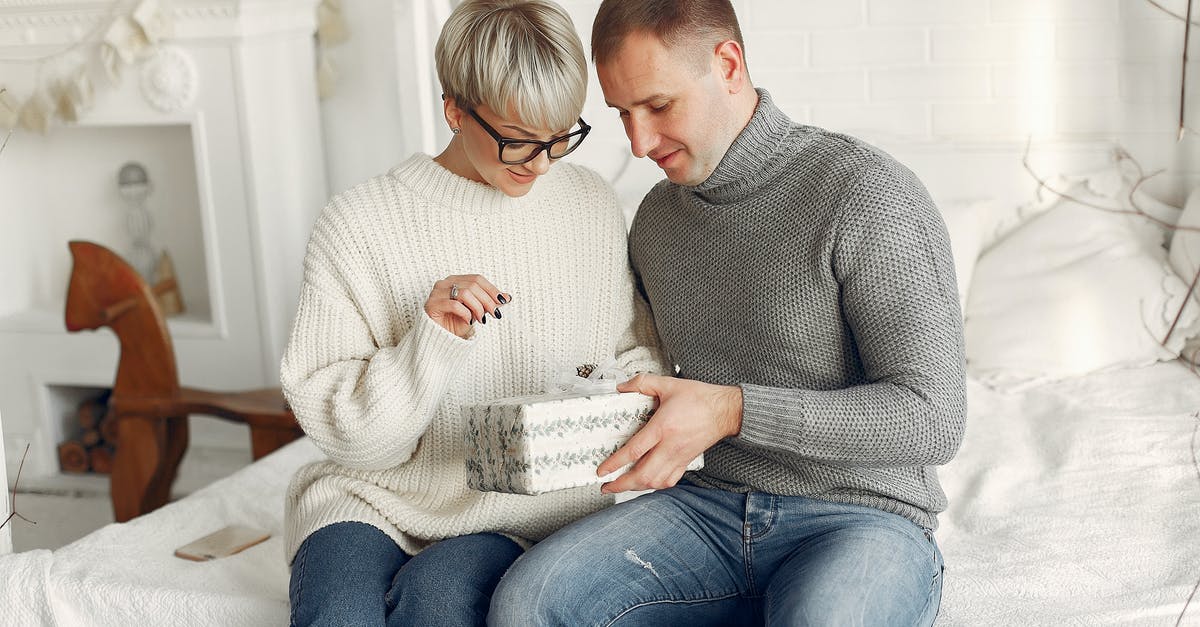 Got French Schengen visa but no "VIS" after giving fingerprints - Couple Holding a Christmas Gift 