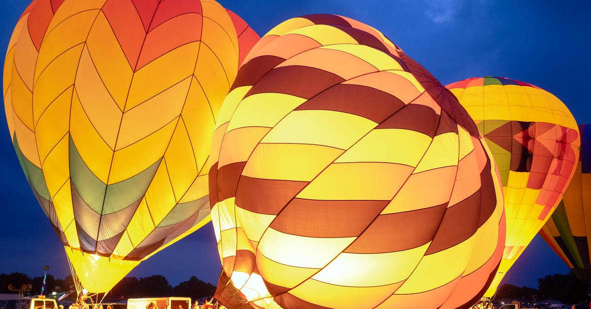 Ground transport and overnight stay - Group of people preparing bright air balloons to fly