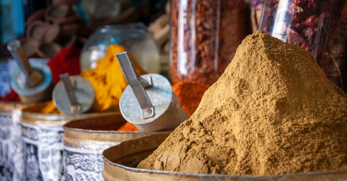 Guinea Bissau national transiting in Morocco - Various colorful spices in local market on sunny day