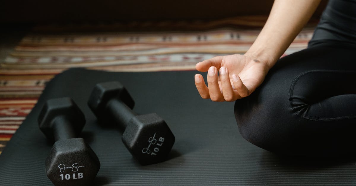 Hand luggage weight? [closed] - Close-Up Shot of Dumbbells near a Person on a Yoga Mat