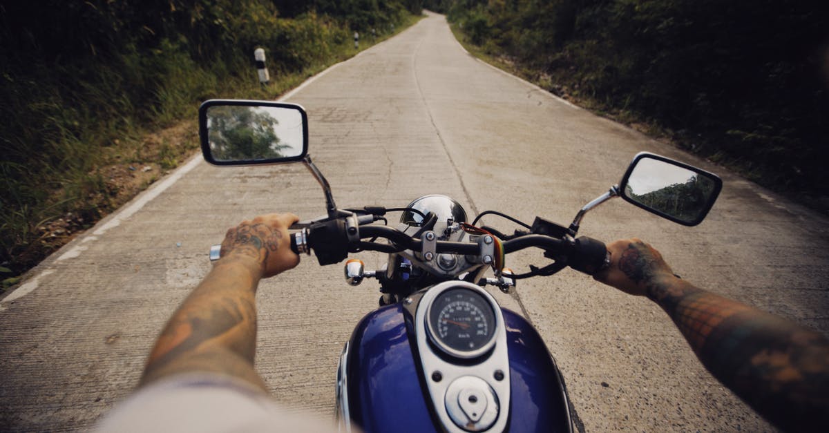 Handles and carryon baggage sizing - Man Riding on Motorcycle on Road