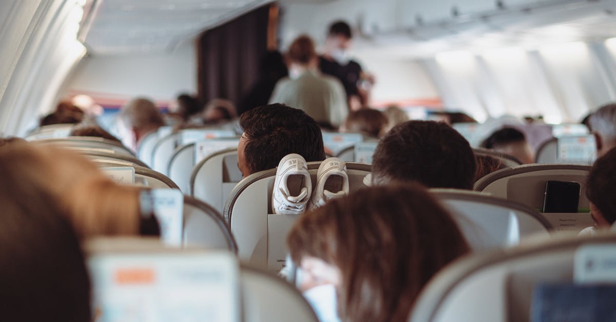 Handling talkative neighbors when travelling [duplicate] - People Sitting on White Chairs