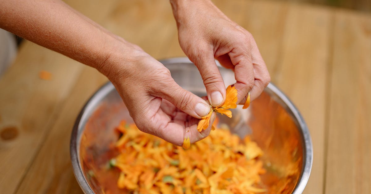 Hands in pockets when going through metal detector causes problems? - Woman Tearing Orange Petals into a Metal Bowl