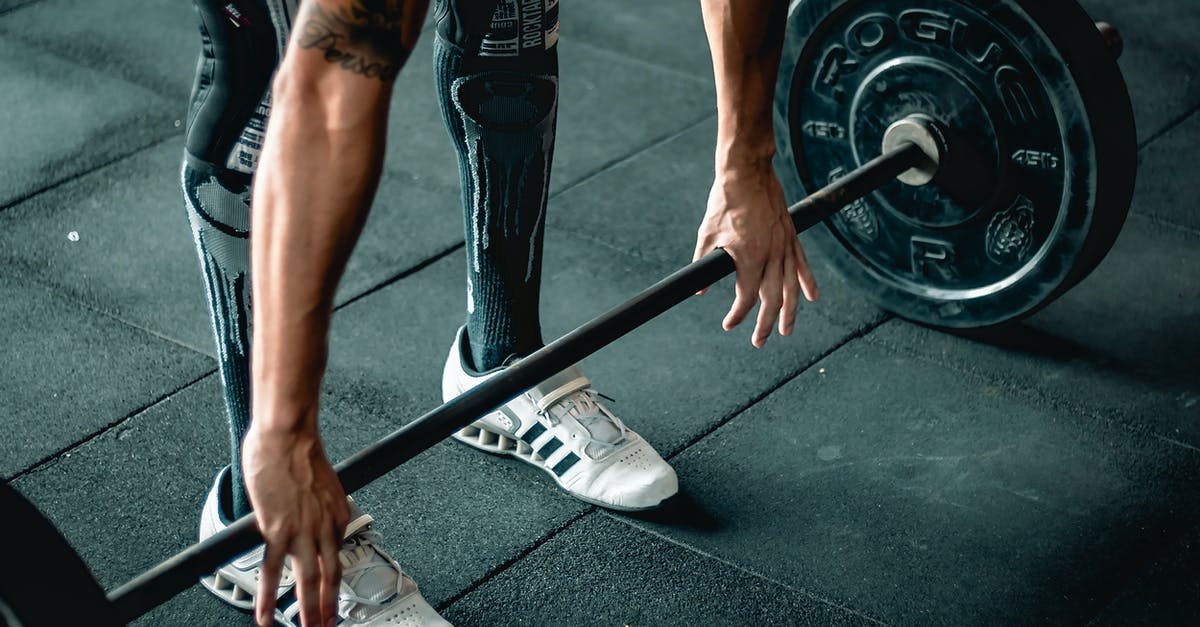 Hands in pockets when going through metal detector causes problems? - Man Using Barbell