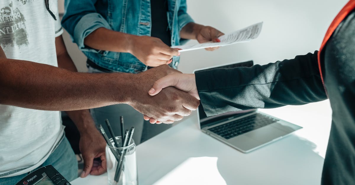 Handshake while holding own right elbow - People Doing a Handshake