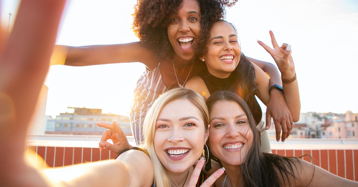 Have any airlines ever banned anyone for exploiting hidden city or throwaway ticketing? - Cheerful young diverse women showing V sign while taking selfie on rooftop Have any airlines ever banned anyone for exploiting hidden city or throwaway ticketing? - Cheerful young diverse women showing V sign while taking selfie on rooftop