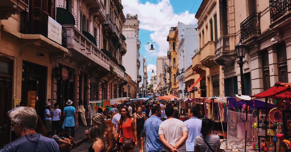 Having pesos before arriving in Argentina - People Standing on Road Beside Market and High-rise Buildings