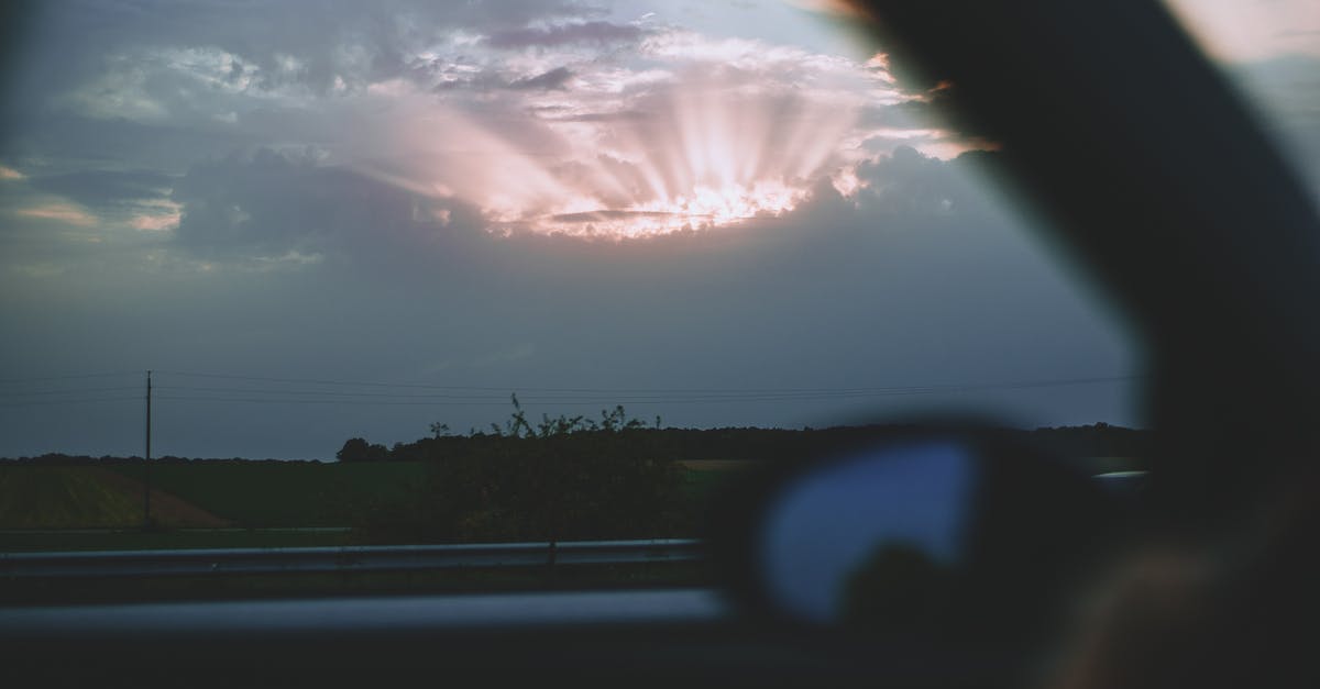 Hazards on road trip through Italian Alps - Car riding through field in evening