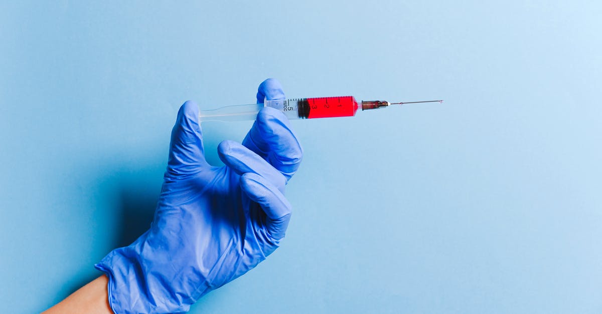 Health vaccinations for UK - Person Holding Syringe