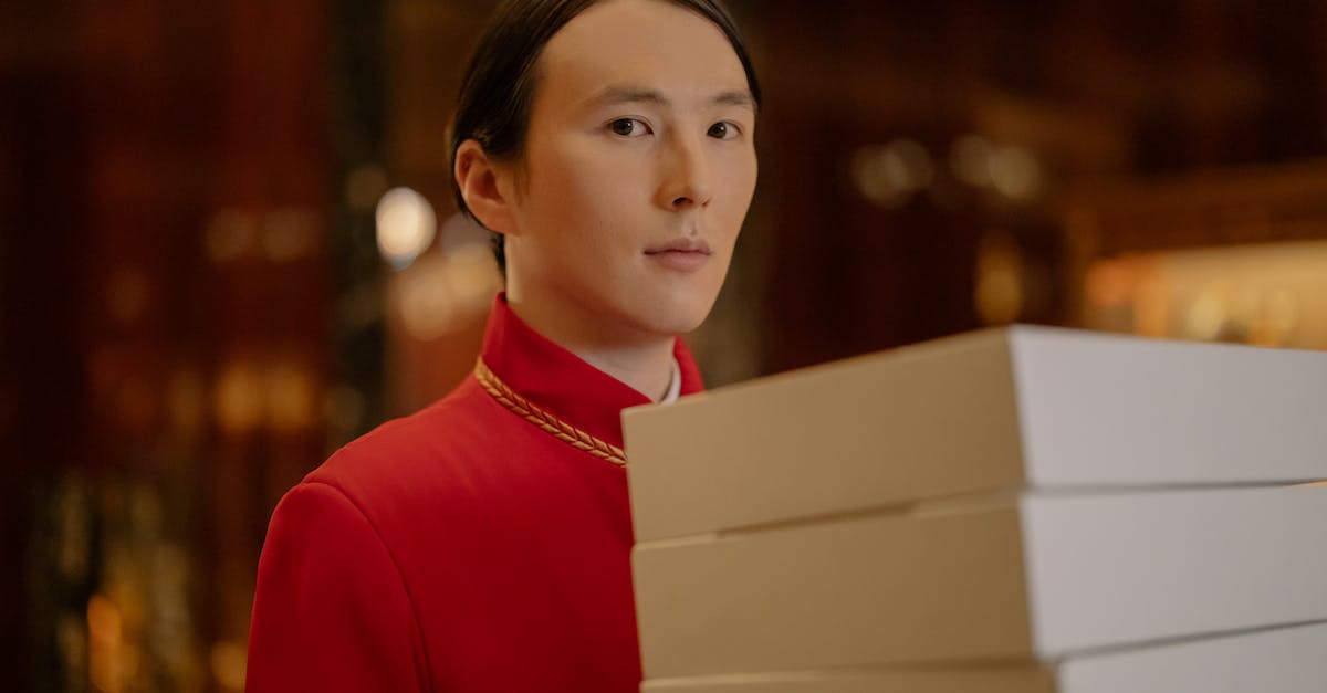 Help remembering name of  hotel in near Łódź, Poland? - Man Carrying White Boxes