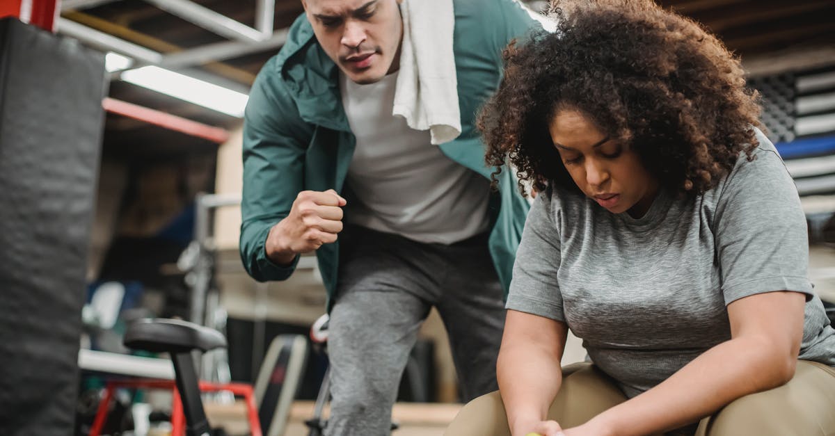 Help Understanding RV Towing Weights - From below of strong personal coach explaining black woman how to exercise with dumbbells properly