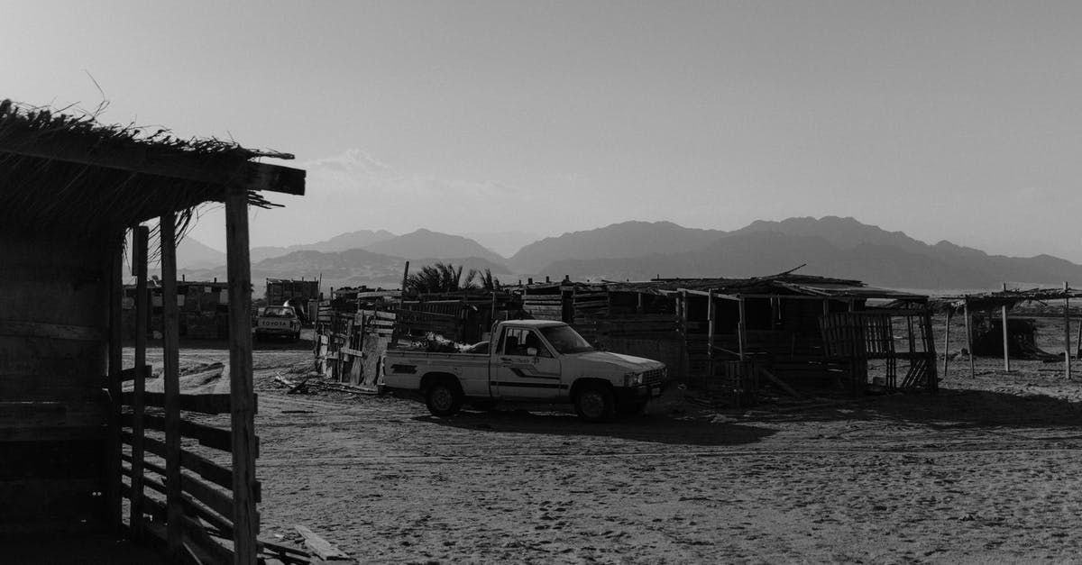 Hertz@SFO: Park during car pickup - Grayscale Photo of a Pickup Car Parked on the Sand