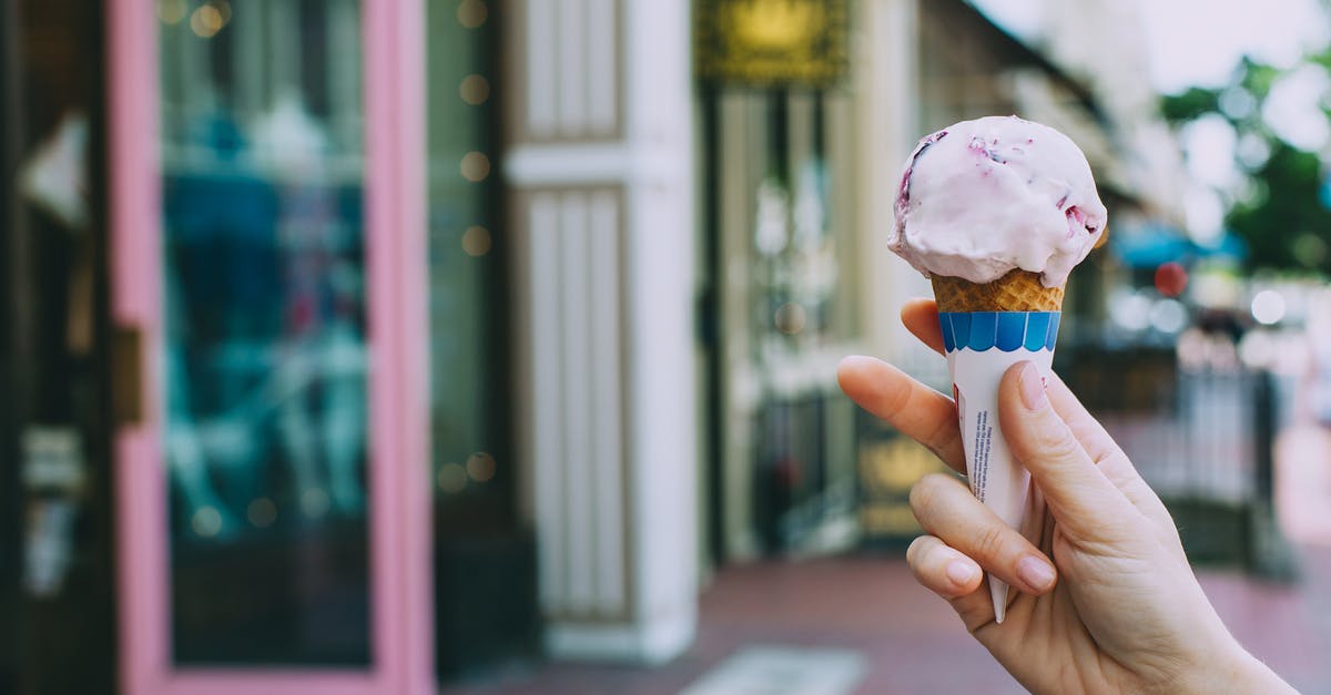 Hidden City Ticketing - asking airline to change portion - Crop person showing delicious ice cream cone on street