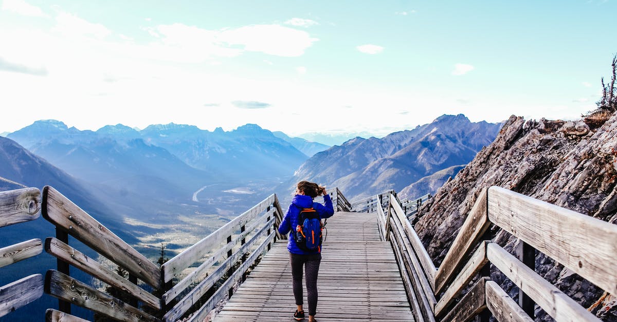 Hiking / nature walking in Cannes area without a car? - Woman Carrying a Backpack Walking on a Wooden Deck