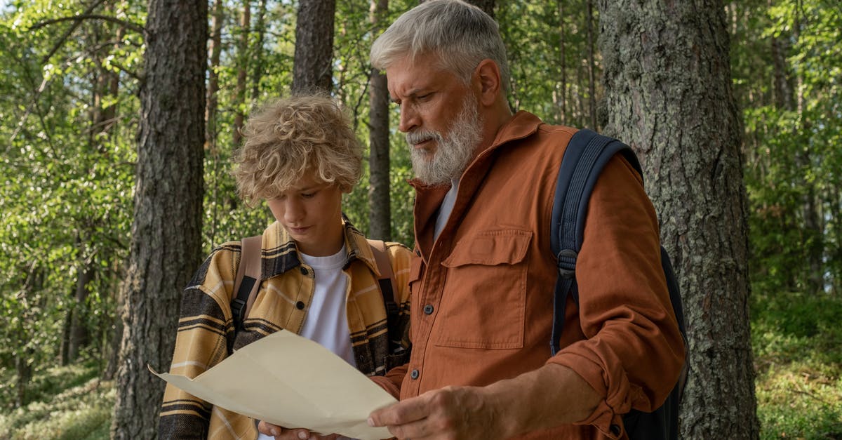 Hiking map for Hokkaido and/or other resources - Grandfather and Grandson with Map during Hiking through Forest