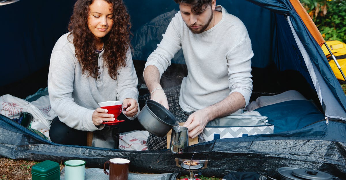 Hiking near Barcelona - or alternative hiking cities close-by? - Crop couple of travelers preparing coffee in tent