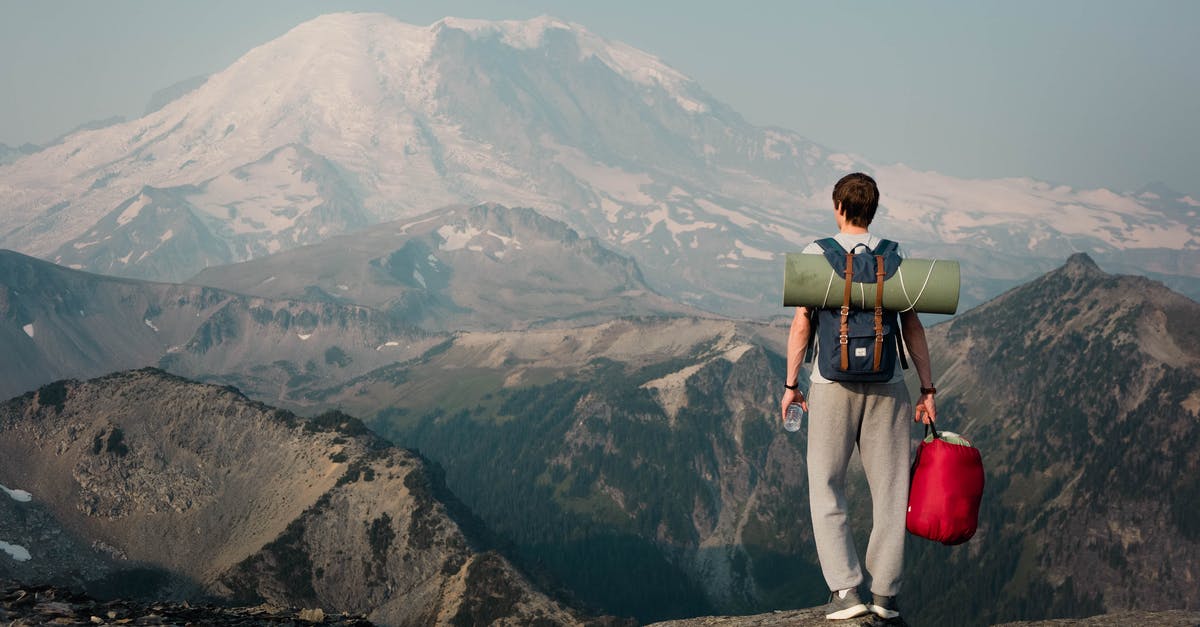 Hiking routes near Embrun - Unrecognizable backpacker standing on top of mountain