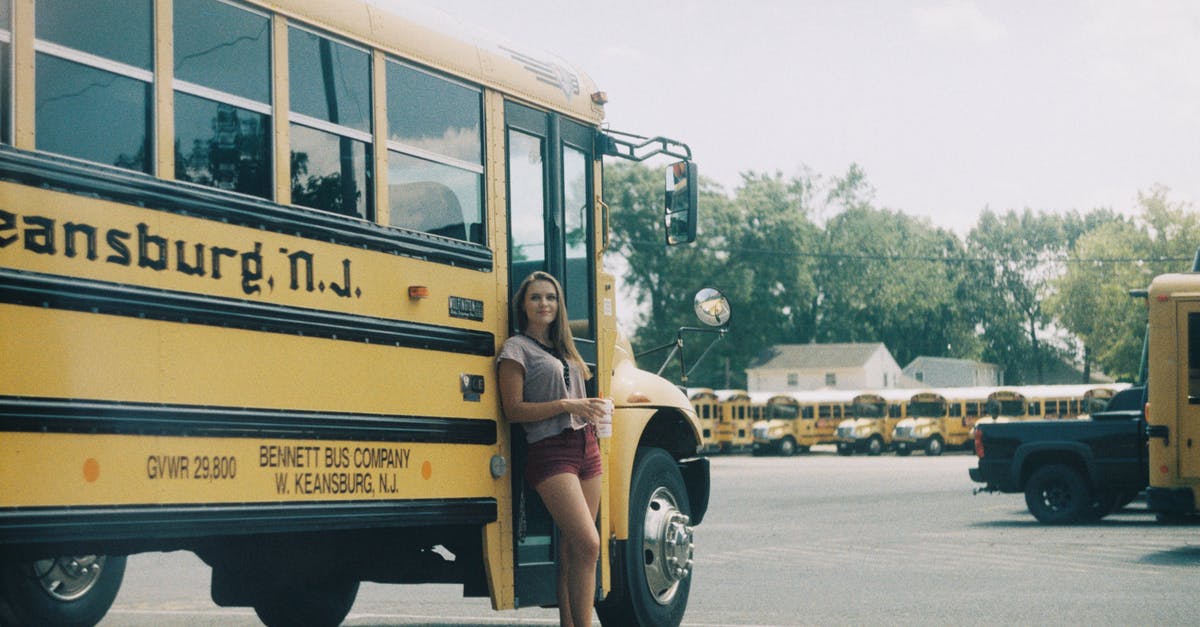 Hirtshals parking for 3 days - Cheerful woman standing near public bus