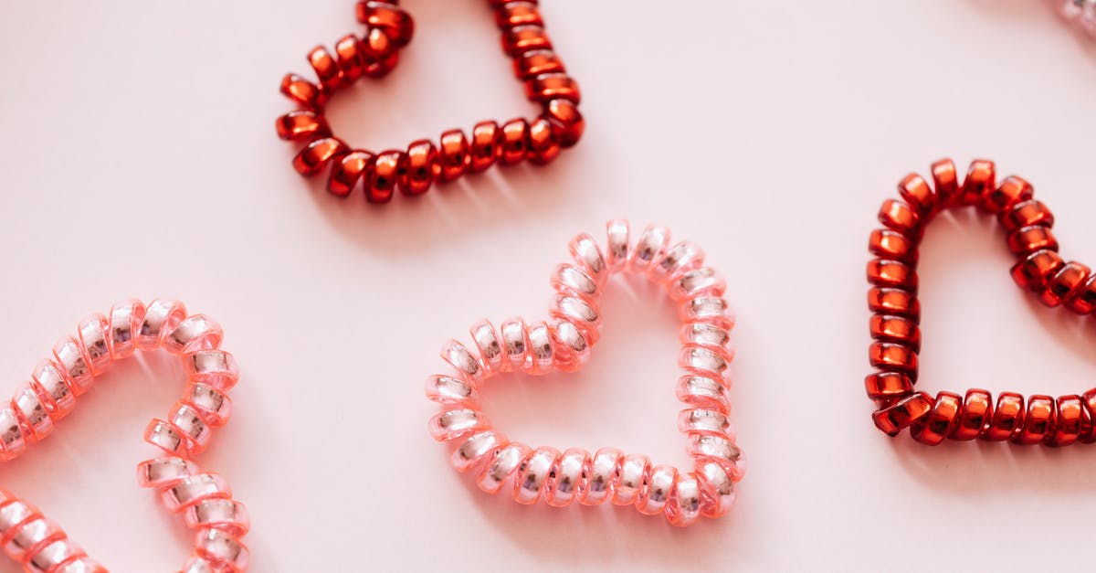 holiday from Munich [closed] - Colorful hair ties in shape of hearts on pink surface