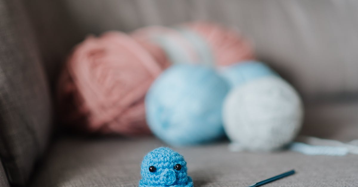 Hook turn limitations [closed] - Small soft knitted animal toy with crochet hook and balls of yarn on cozy sofa